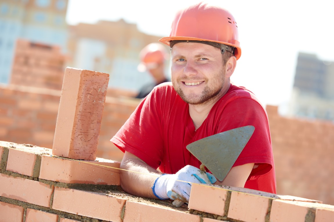 Construction,Worker.,Portrait,Of,Mason,Bricklayer,Installing,Red,Brick,With
